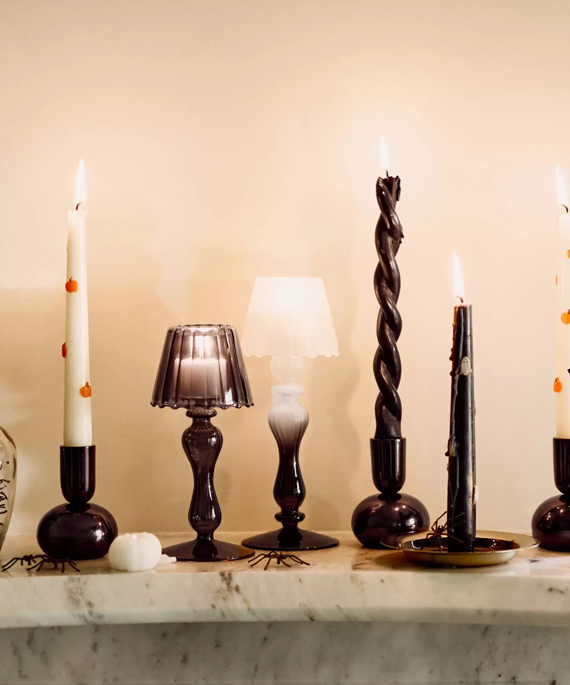 Black taper candle holders with white Halloween motif candles