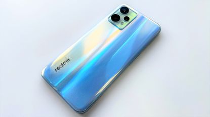 Realme 9 Pro review: woman dancing and holding a blue phone