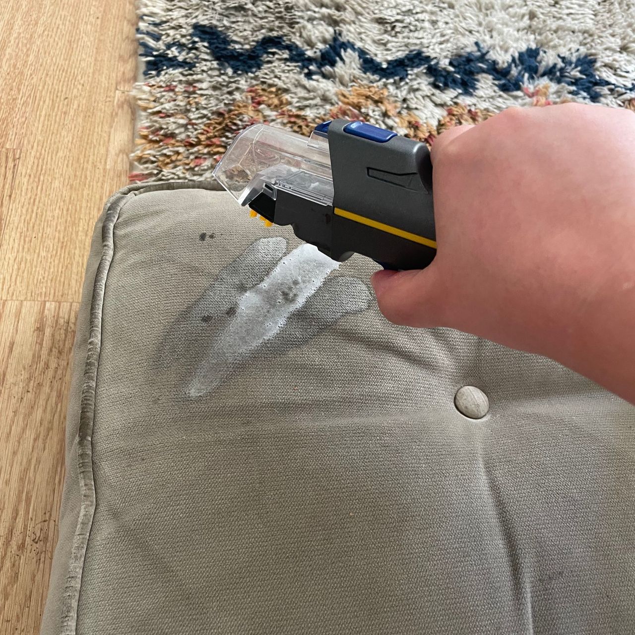 Using the Shark CarpetXpert HairPro Pet Deep Carpet Cleaner with Spot Cleaner EX250UK on a stained sofa cushion