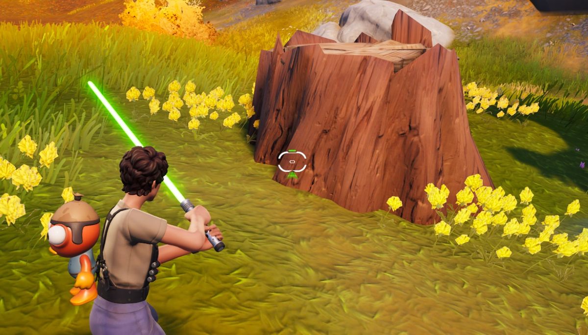 Fortnite - A player holds a lightsaber while looking at a tree stump of a timber pine