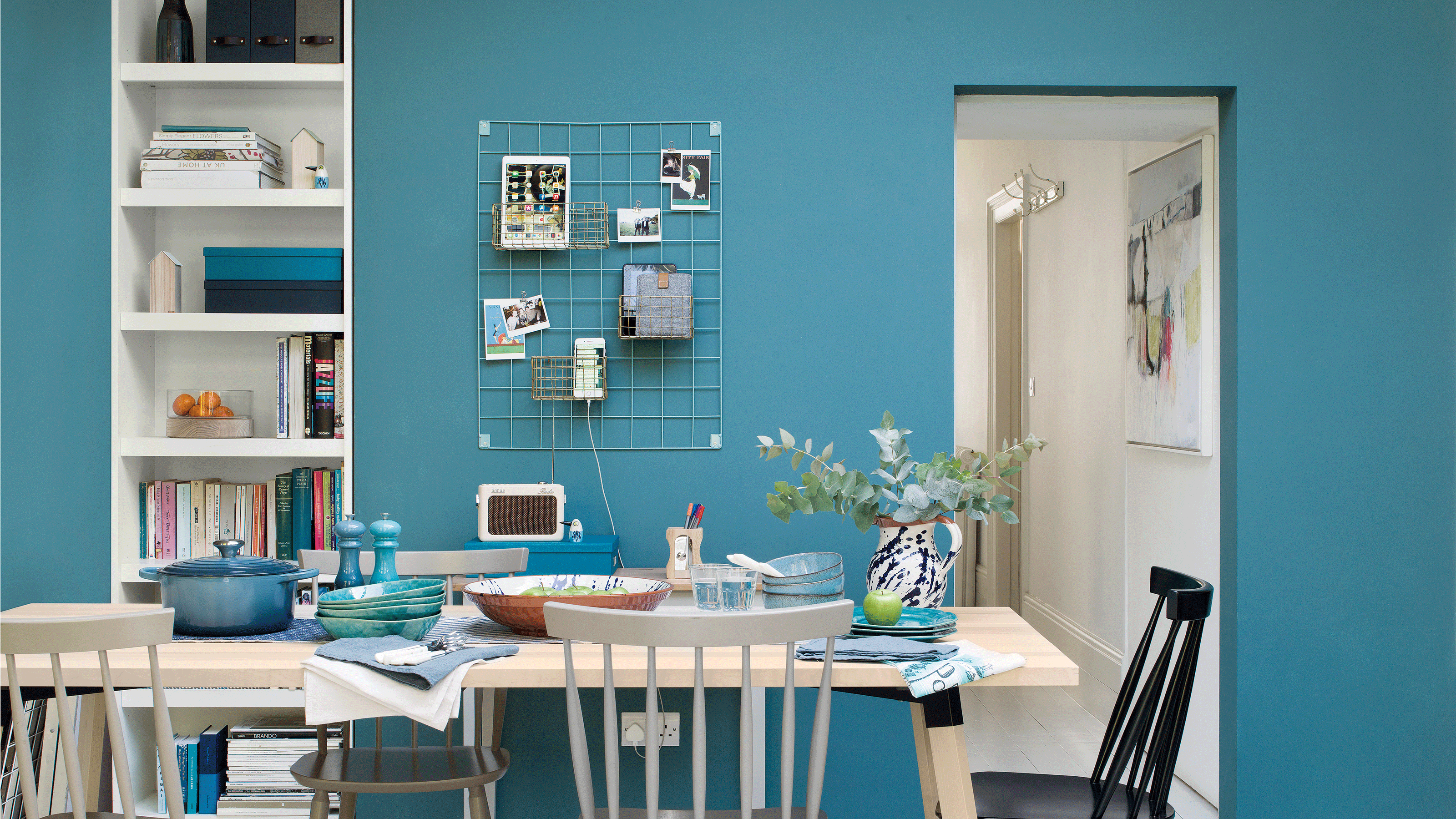 Blue kitchen with white table 