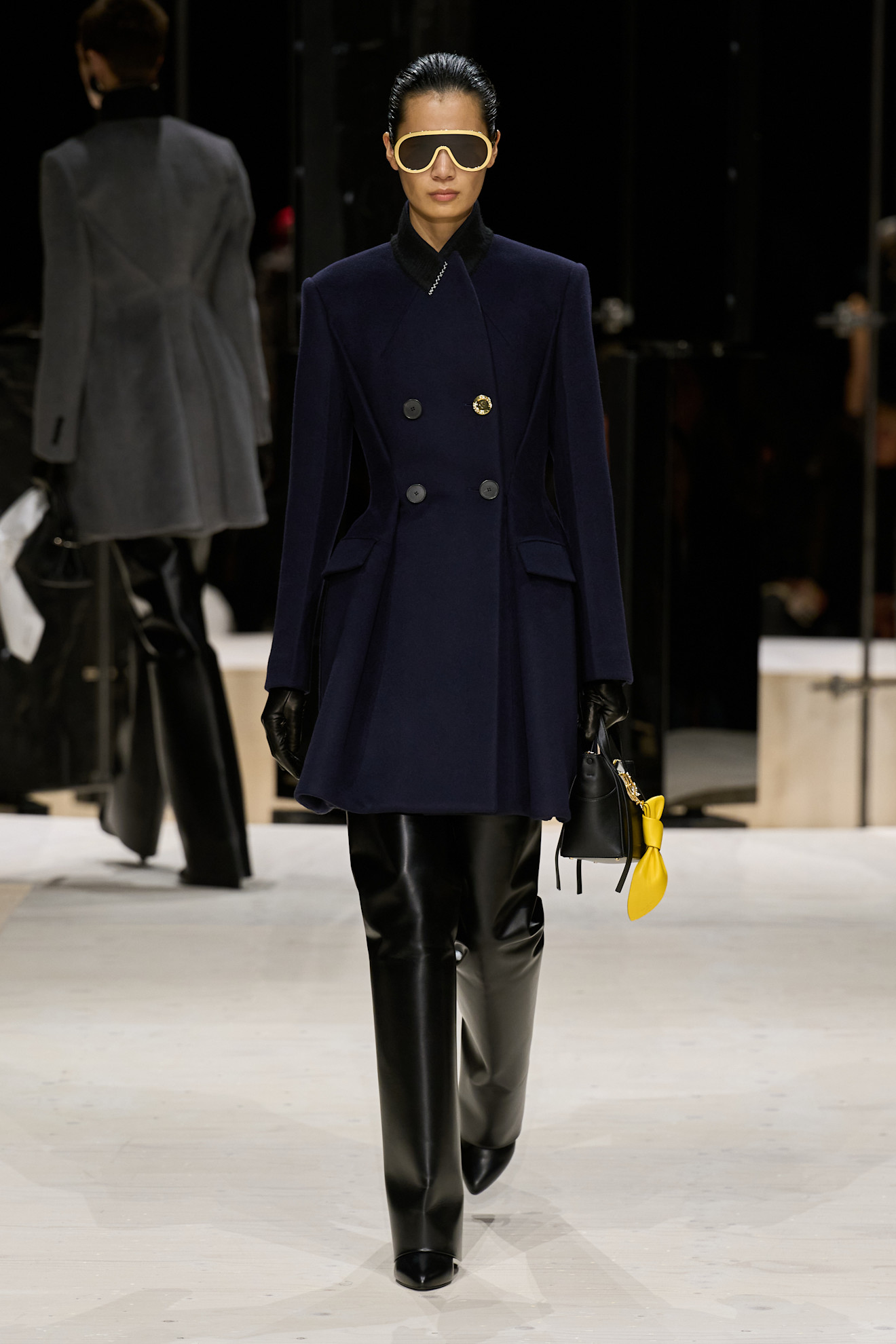 a givenchy model wears knife boots on f/w 26 runway.