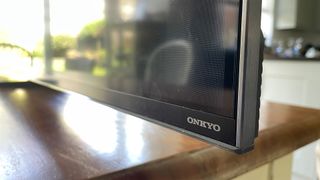 TCL 85C805K 4K TV bottom corner of TV showing Onkyo branding