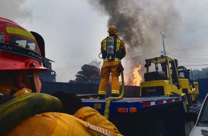 Los Angeles County Firefighters work to extinguish commercial fire at a warehouse in Maywood, Calif. on Tuesday, June 14, 2016
