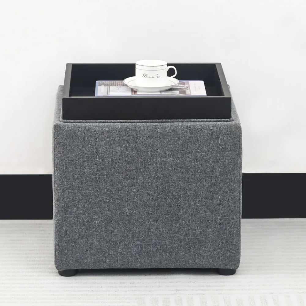 Gray upholstered ottoman with black tray