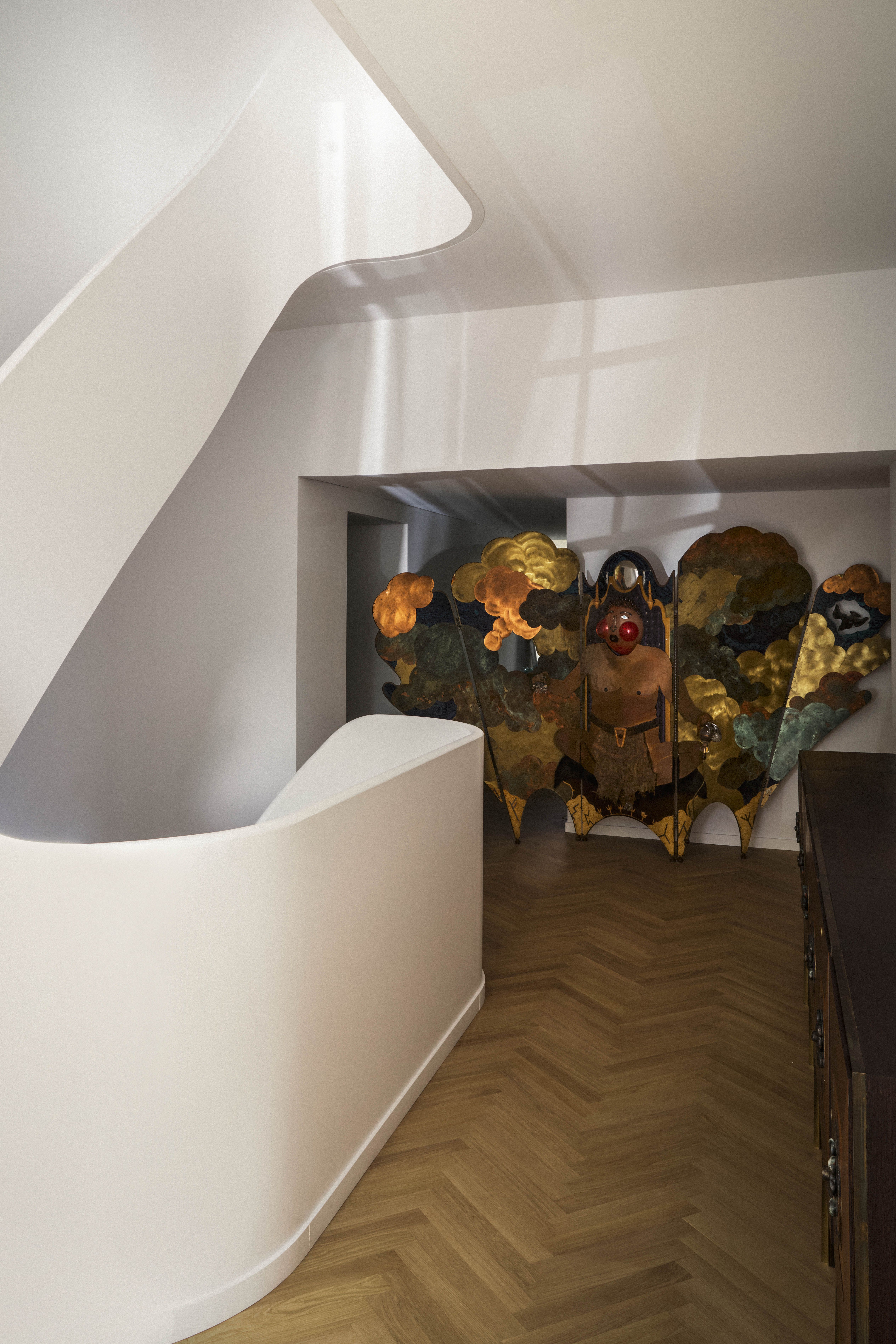 This winding staircase has a sculptural quality, with a printed runner 