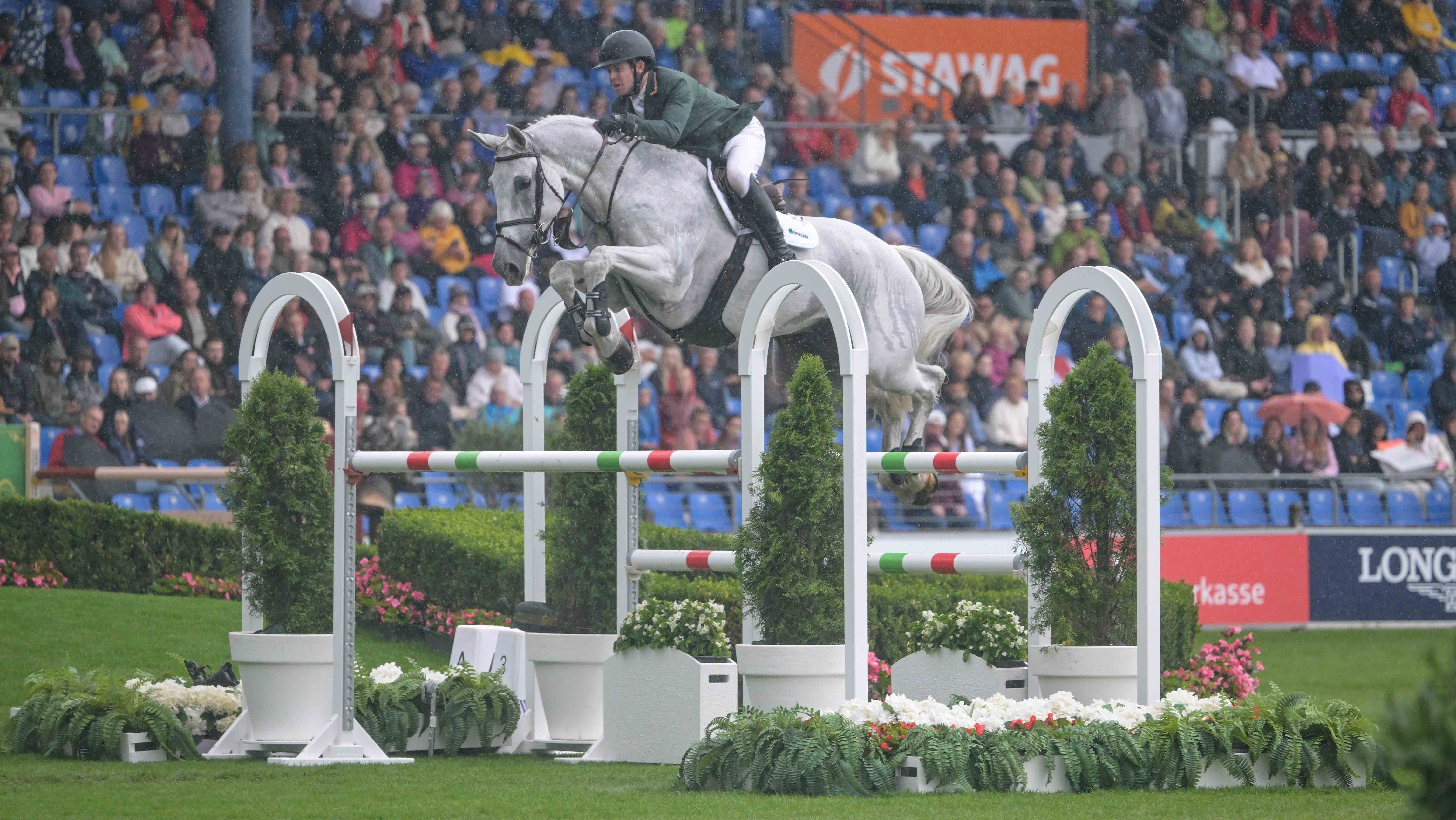 Shane Sweetnam and James Kann Cruz jump a multi-coloured fence while helping Ireland qualify for the showjumping World Championships team final