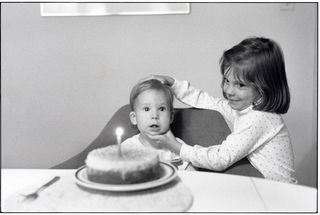 birthday photograph of boy posed by sister