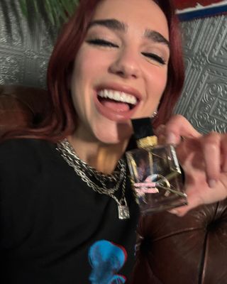 @dualipa holding YSL Libre perfume