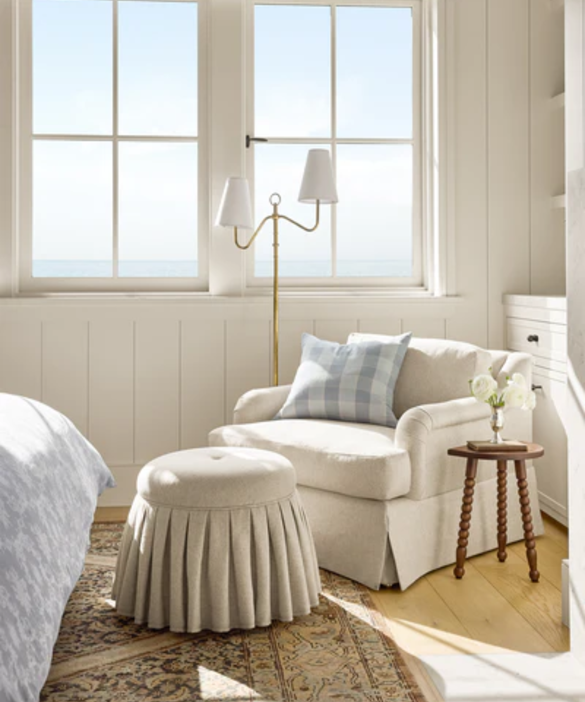 a lounge chair with an ottoman and a plaid pillow