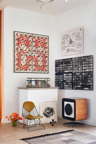A corner with Eames designs and artworks on the walls