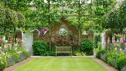 Courtyard garden with bench, flower beds on either side