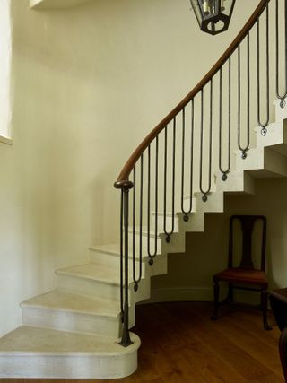 Elegant simplicity: the new cantilevered staircase with ironwork baluster, part of the remodelling and extending that took place between 2014 and 2018. Credit: Paul Highnam/Country Life Library