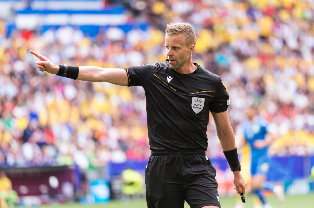 Referee Glenn Nyberg gestures during the UEFA EURO 2024 group stage match between Romania and Ukraine at Munich Football Arena on June 17, 2024 in Munich, Germany.