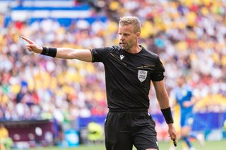 Referee Glenn Nyberg gestures during the UEFA EURO 2024 group stage match between Romania and Ukraine at Munich Football Arena on June 17, 2024 in Munich, Germany.