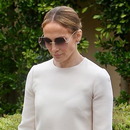 Jennifer Lopez wears a white shift dress with oversize sunglasses and a birkin bag while attending sam affleck's graduation
