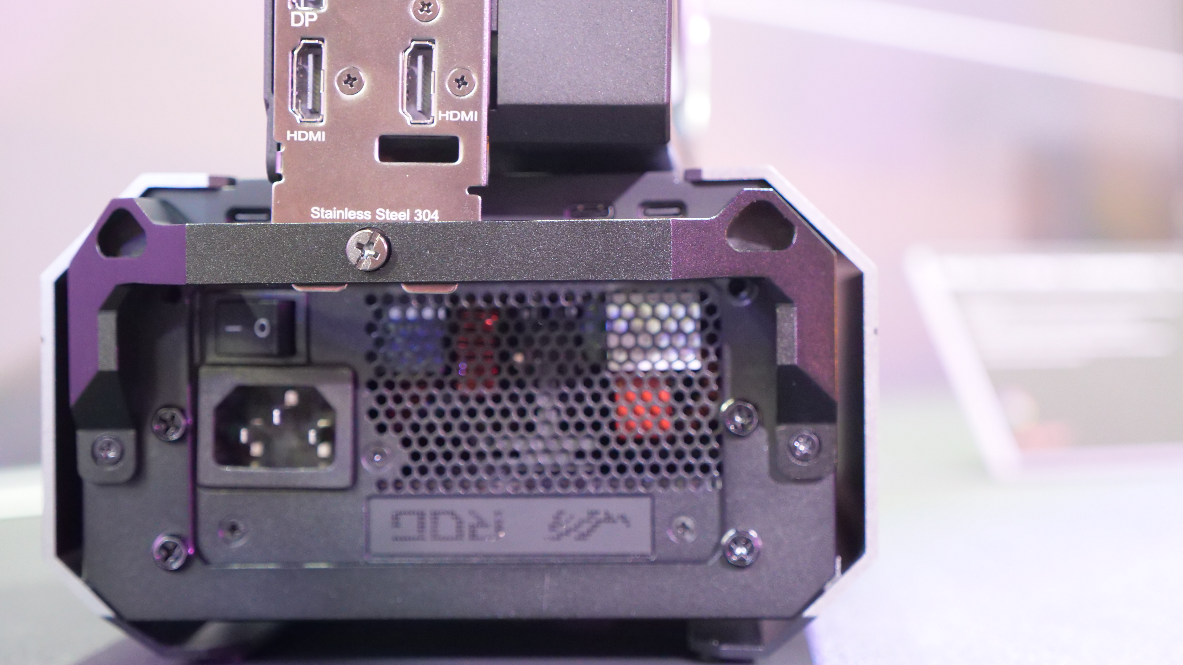 Asus ROG XG Station 3 on a desk at Computex 2025, image shows a close-up of the rear of the GPU, showing its PSU.