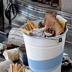 blue and white steel bucket with wooden materials paper cloth and box