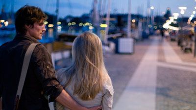 couple walking on a pier