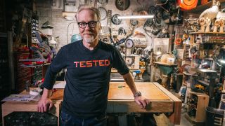Adam Savage with a Tested shirt on, in his workshop