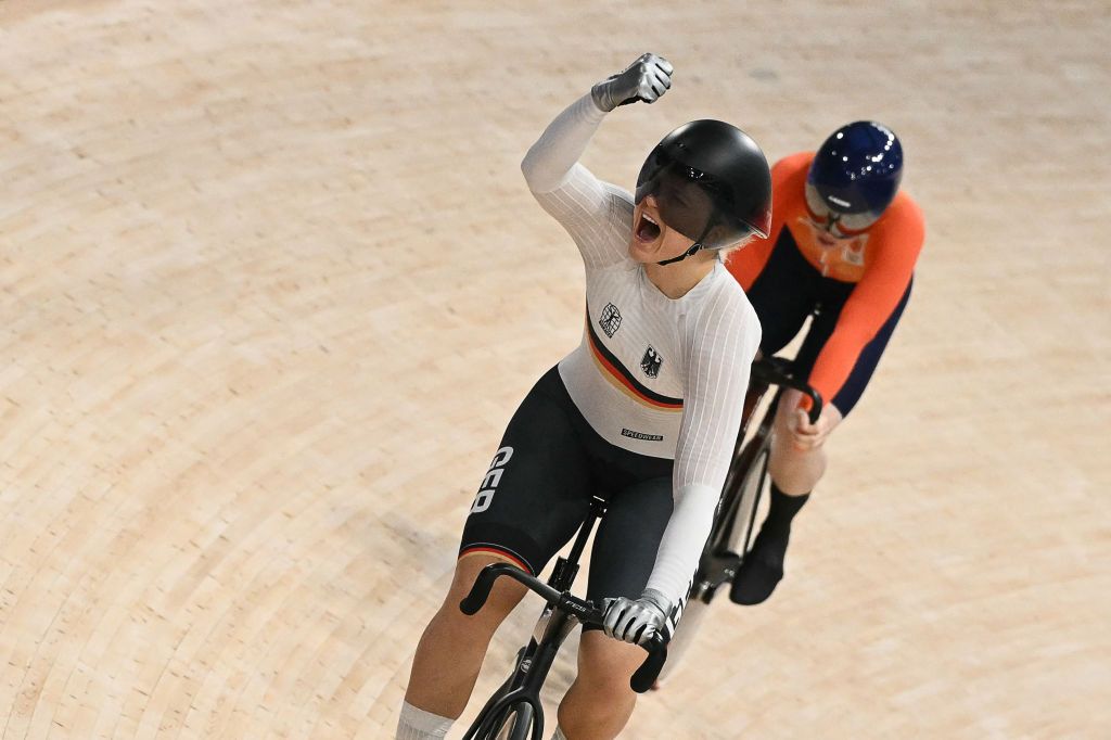 Germany's Lea Sophie Friedrich (L) reacts after winning against Netherlands' Hetty van de Wouw in a women's track cycling sprint semi-final decider of the Paris 2024 Olympic Games at the Saint-Quentin-en-Yvelines National Velodrome in Montigny-le-Bretonneux, south-west of Paris, on August 11, 2024. (Photo by SEBASTIEN BOZON / AFP)
