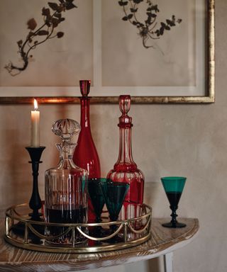Candles on drinks tray with carafes