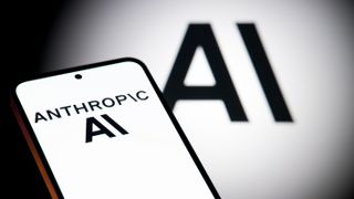 The Anthropic AI logo is displayed on a mobile phone with the company AI branding visible in the background, in this photo illustration in Brussels, Belgium, on December 7, 2025. (Photo by Jonathan Raa/NurPhoto via Getty Images)