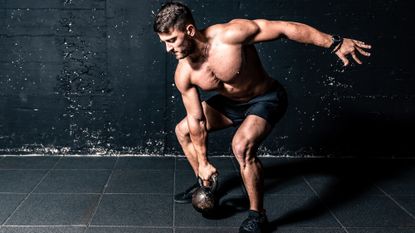 Man swining a kettlebell for rotational strength training