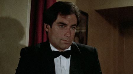 A close up of Timothy Dalton as James Bond, looking serious in a tuxedo in The Living Daylights