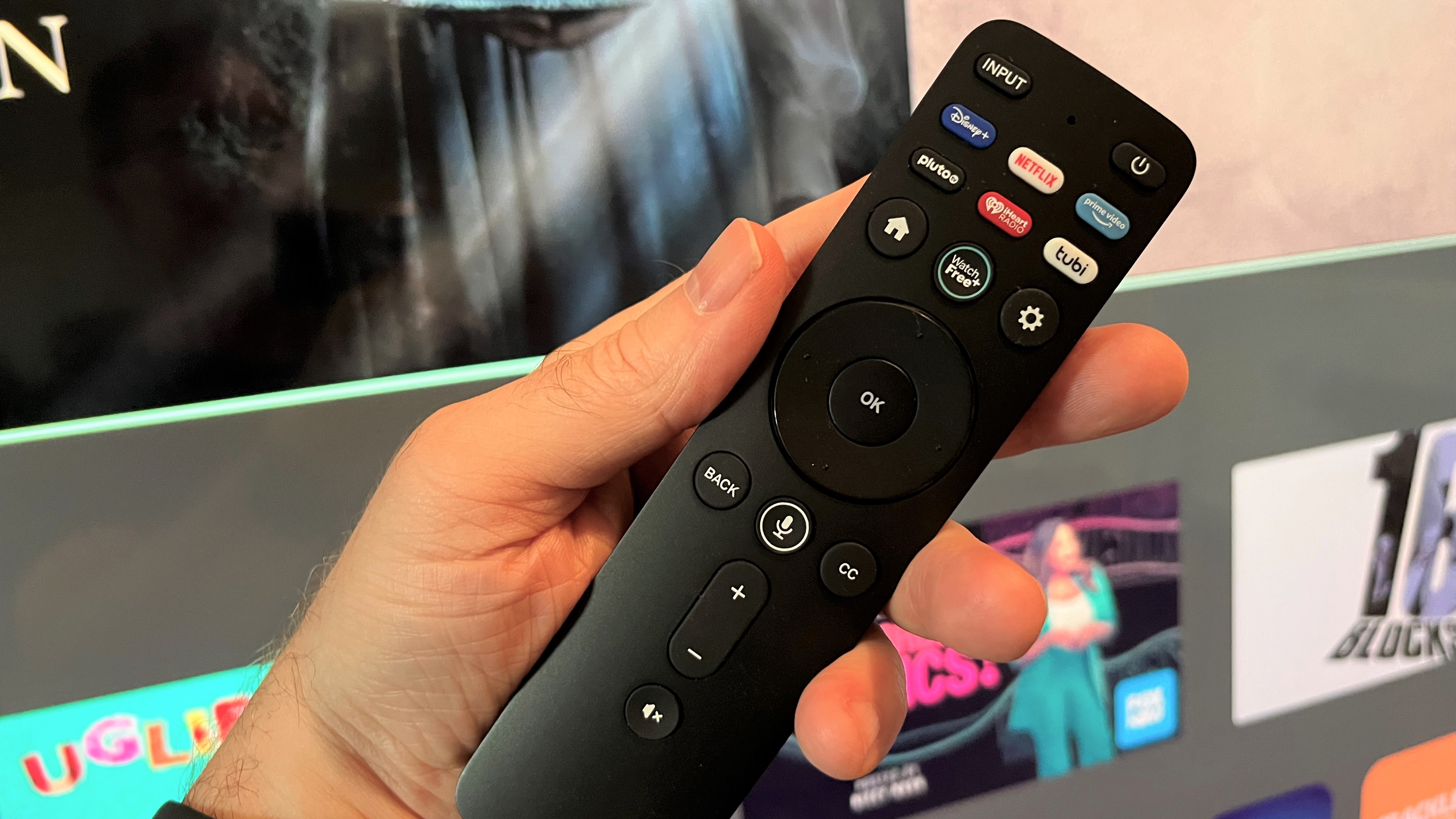 Vizio M65QXM remote control held in hand