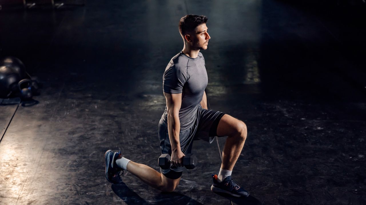 A man performing dumbbell lunges