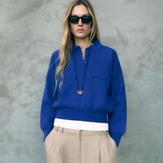 Woman in cerulean blue sweater and beige pants