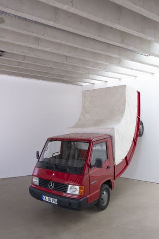 Truck bending up wall. Part of Erwin Wurm exhibition at Yorkshire Sculpture Park