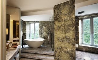 The bathroom, framed with seductive Bruno Elegante stone from Brazil
