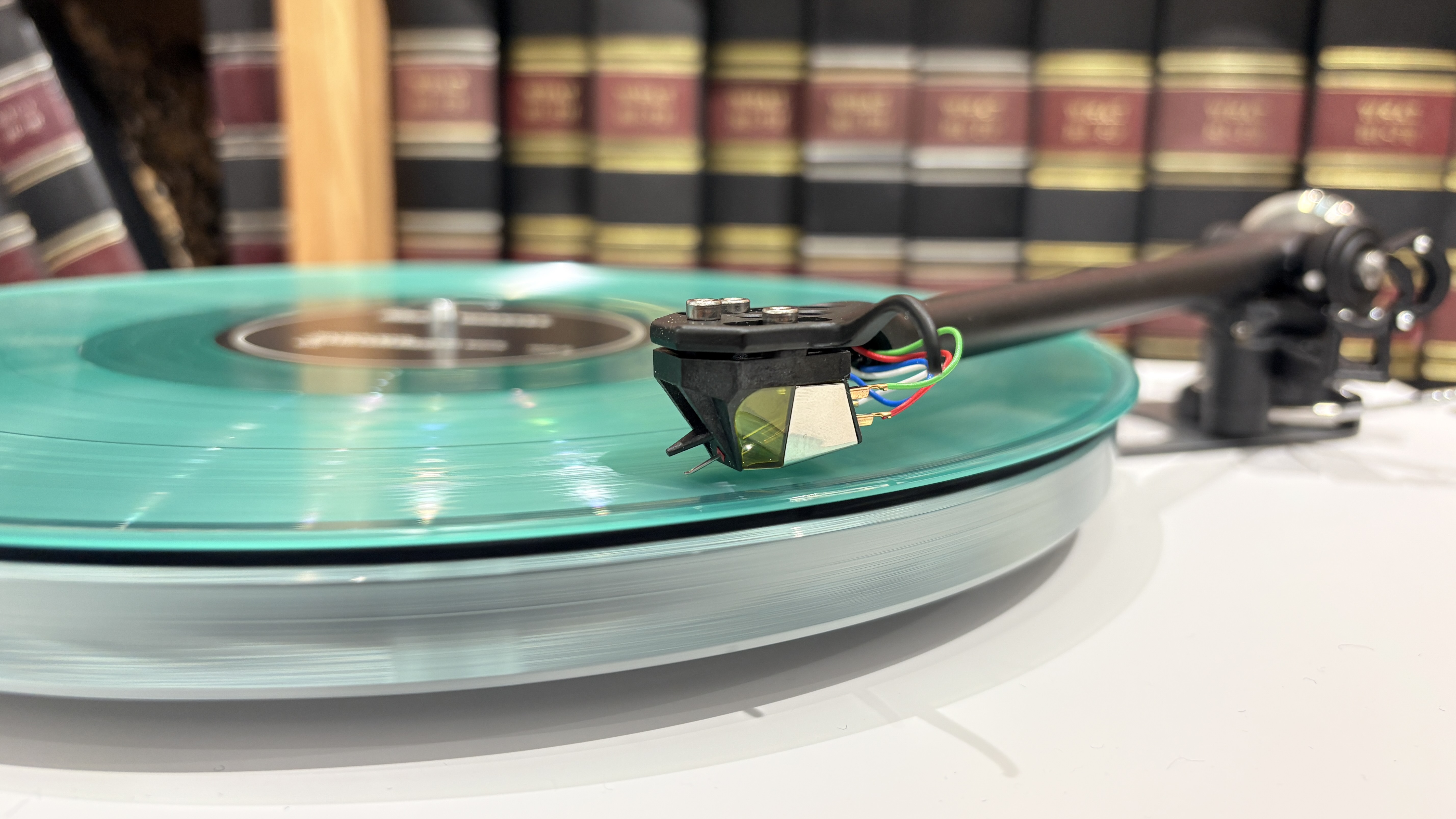 Rega Planar 6/Nd7 in white finish with blue vinyl record playing