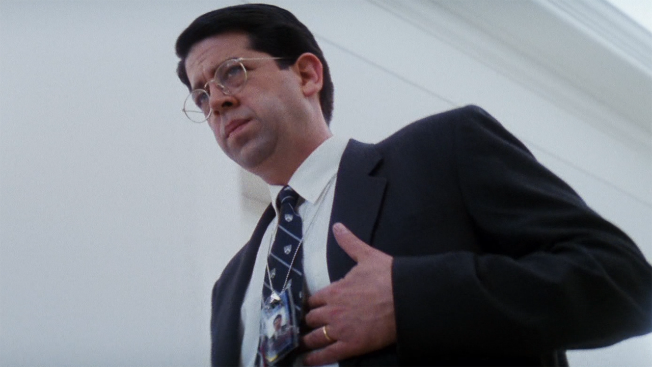 Rolf Saxon holding his stomach with concern in Mission: Impossible.