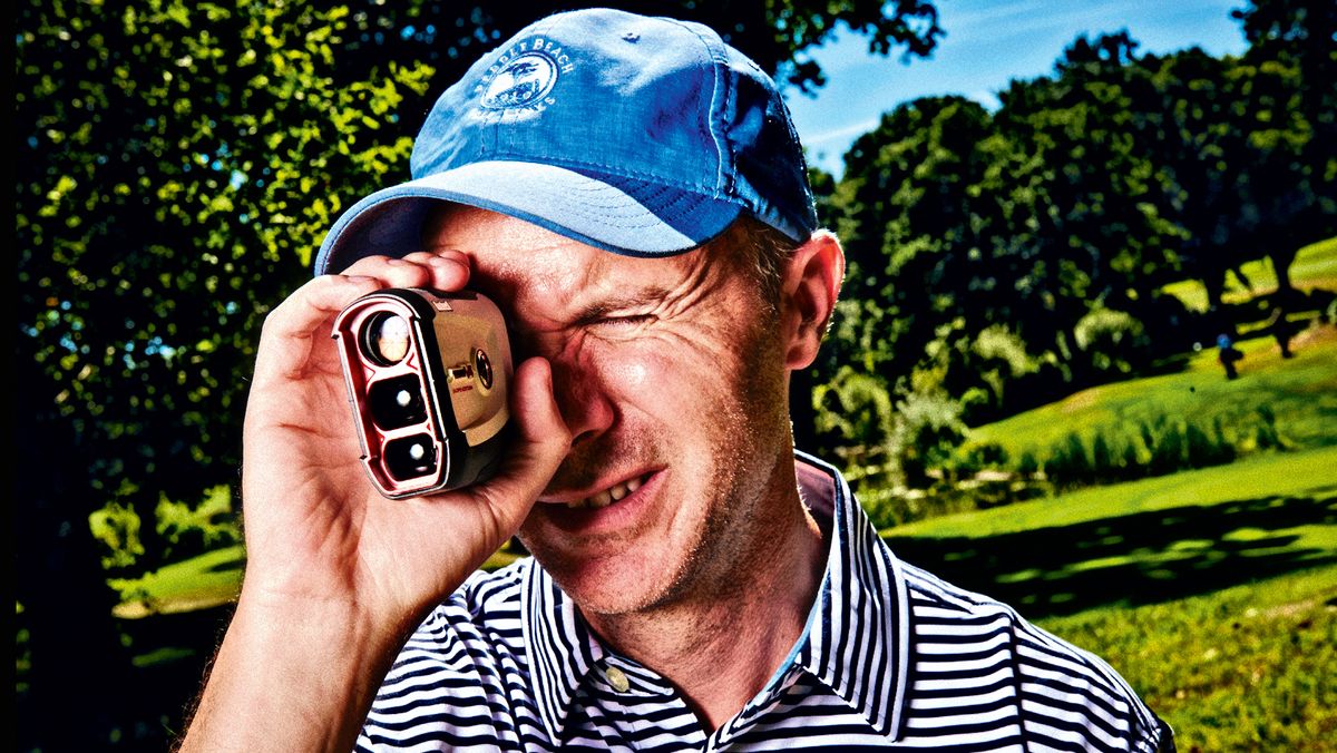 Man on a golf green looking through one of the best laser rangefinders