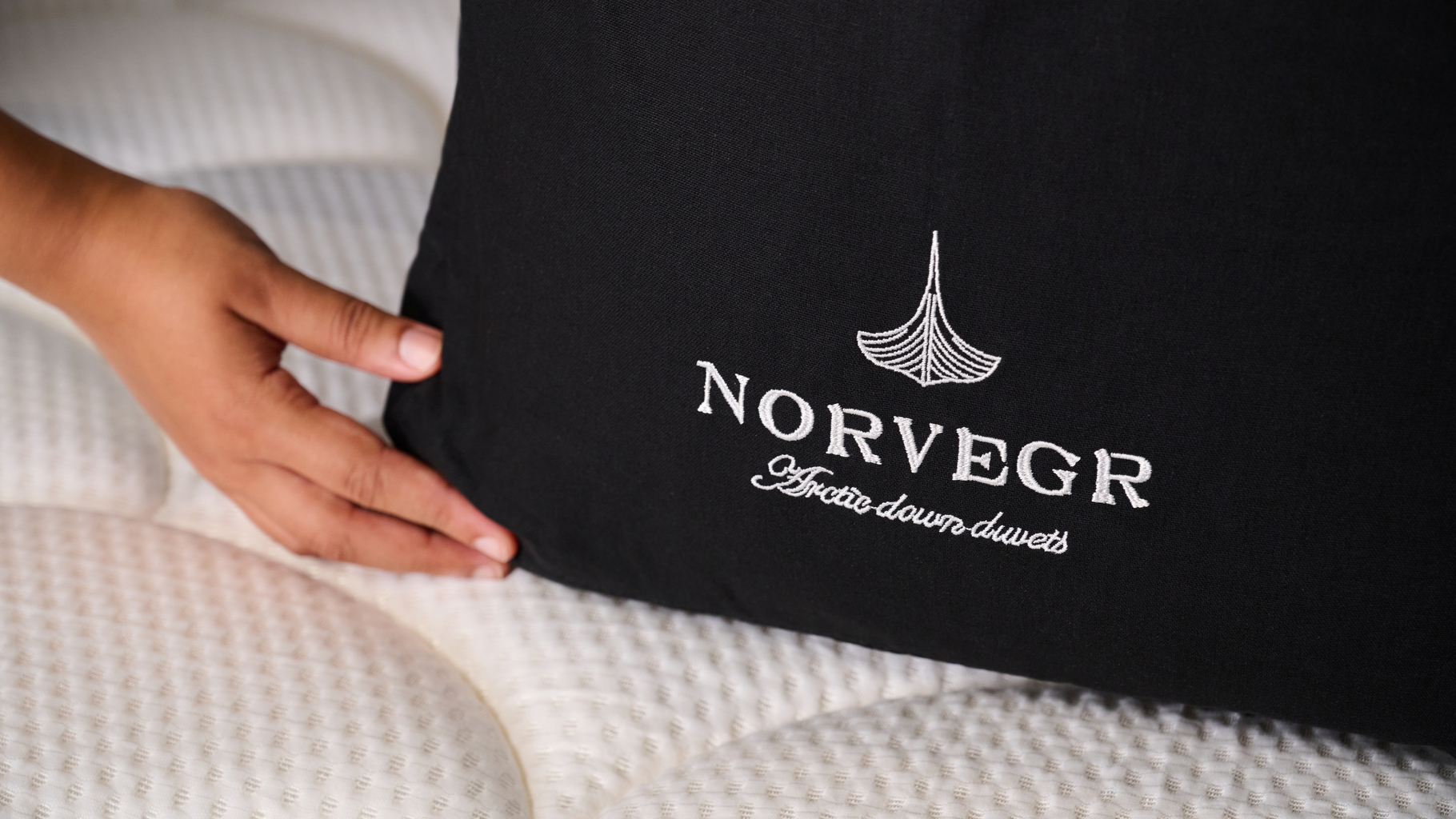 A close up shot of the logo on the Norvegr European White Goose 100% Down Firm Pillow package
