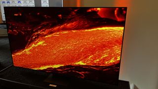 The TCL C84 Series mini-LED TV, showing an image of some molten lava