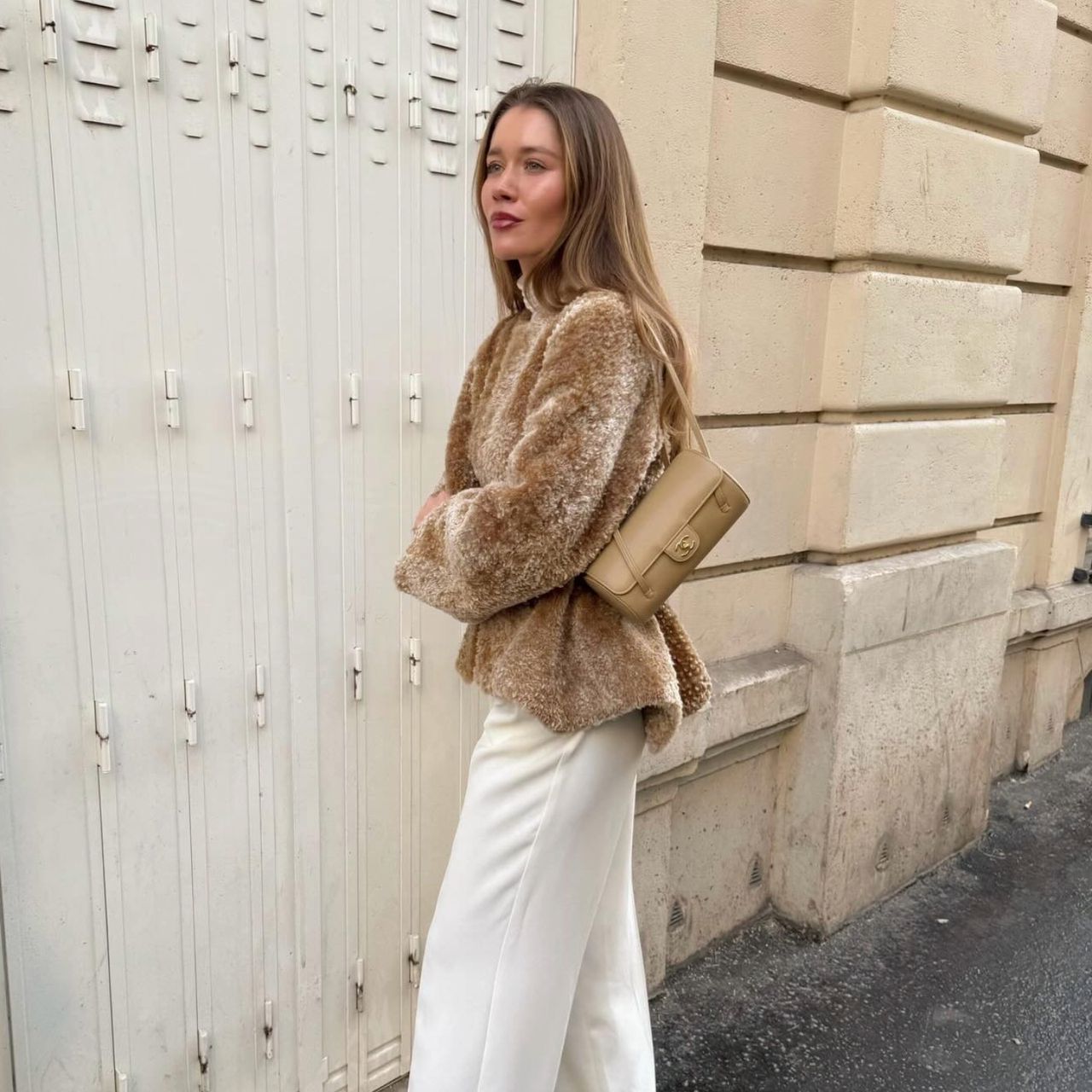 Lovisa Barkman in a faux fur coat and beige Chanel bag