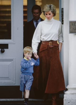 British Royal Prince Harry with his mother, Diana, Princess of Wales (1961-1997), wearing a white turtleneck top and a long brown suede skirt, and his father Charles, Prince of Wales at Wetherby School in Notting Hill, London, England, 15th September 1988. Harry, who is celebrating his fourth birthday, accompanied his parents to drop Prince William off at the school