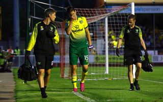 Norwich's Timm Klose walks off after picking up an injury during the Carabao Cup second round match at Crawley