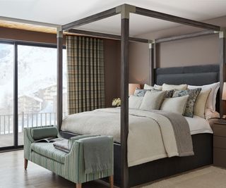 four poster bed in room with large patio doors