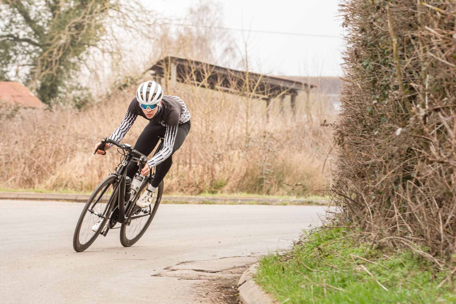 Image shows a rider cornering on a road bike.
