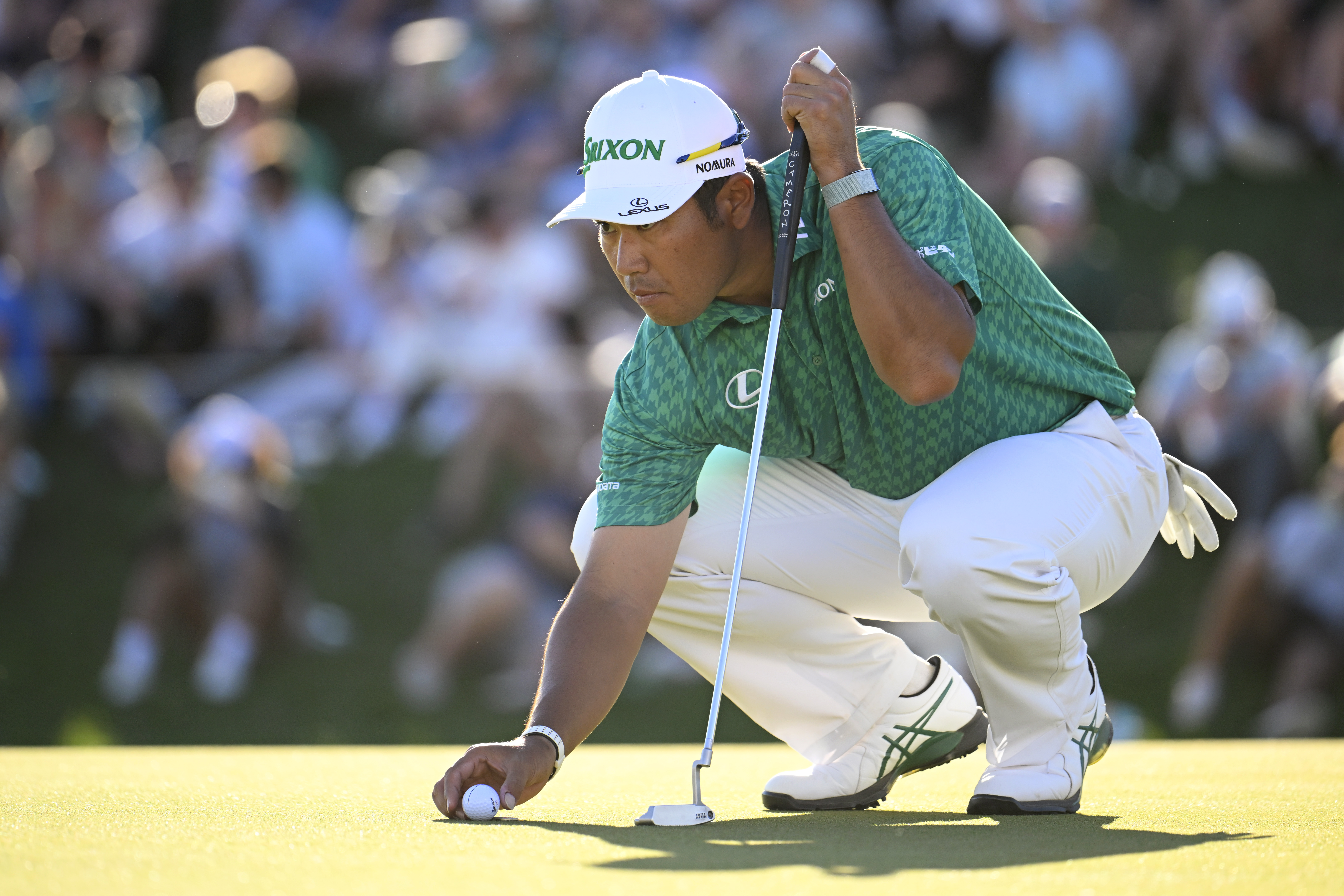 Hideki Matsuyama lines up a putt
