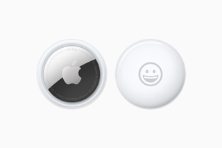 Two views of the Apple AirTag technology device, pictured on a white background