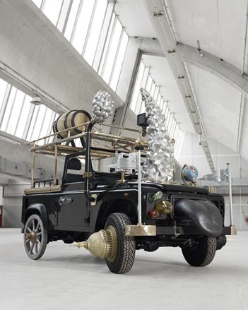 Left: Land Rover Defender, Right: The metal flags are emblazoned with reliefs of the flags of African countries