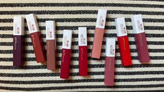 A lineup of multiple shades of Maybelline Superstay Matte Ink Lipstick, for the purpose of the Maybelline Superstay Ink Review