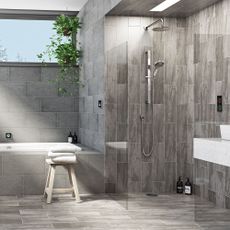 bathroom with grey tiles wall and shower
