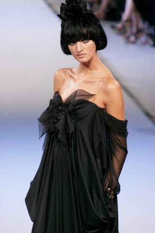 a model walks the runway in christian lacroix's fall/winter 2006 runway show.